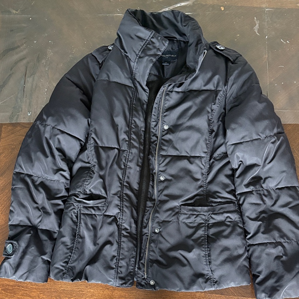 Black quilted winter jacket. Front pockets and nice details.